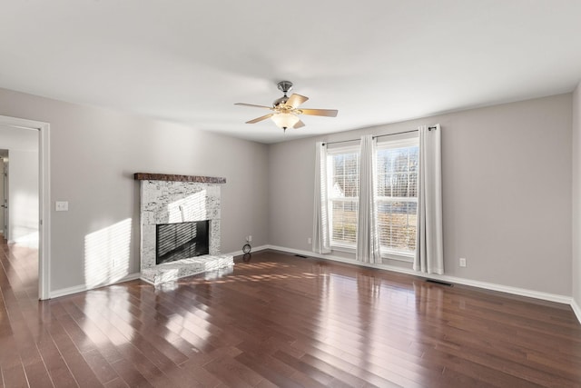 unfurnished living room featuring ceiling fan and dark hardwood / wood-style floors