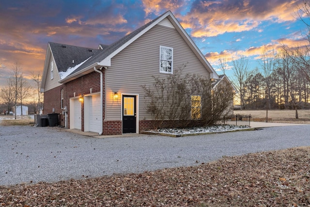 property exterior at dusk featuring a garage