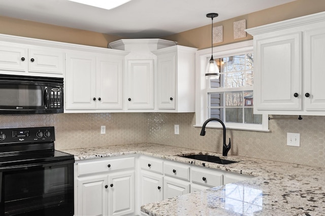 kitchen with white cabinets, black appliances, decorative backsplash, sink, and hanging light fixtures