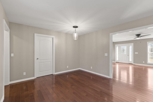 spare room with ceiling fan and dark hardwood / wood-style flooring