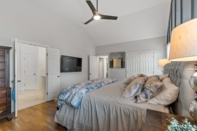 bedroom featuring a closet, ceiling fan, hardwood / wood-style flooring, and lofted ceiling