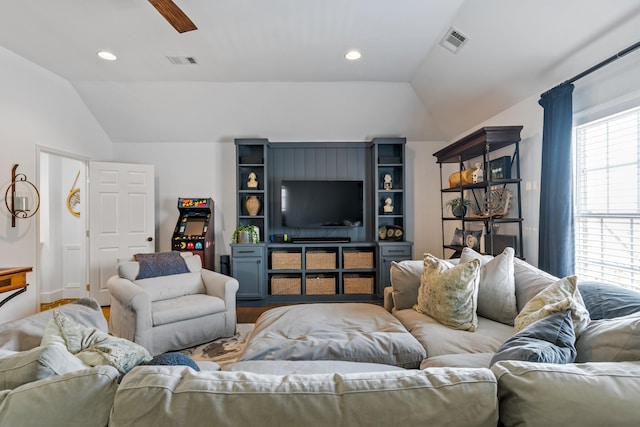 living room with hardwood / wood-style floors, vaulted ceiling, and ceiling fan