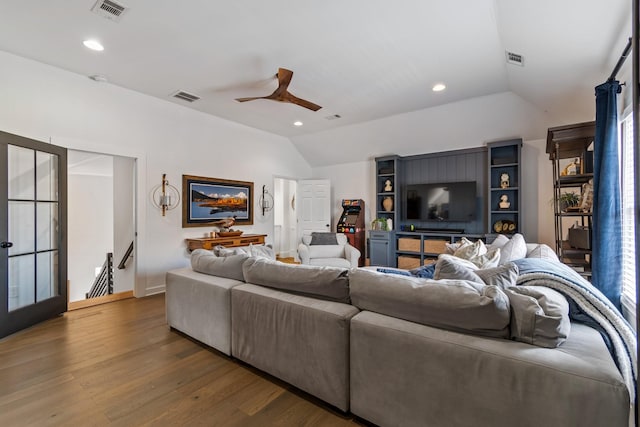 living room with ceiling fan, dark wood-type flooring, and lofted ceiling