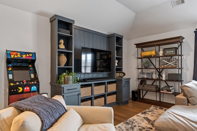 living room with dark hardwood / wood-style flooring and vaulted ceiling