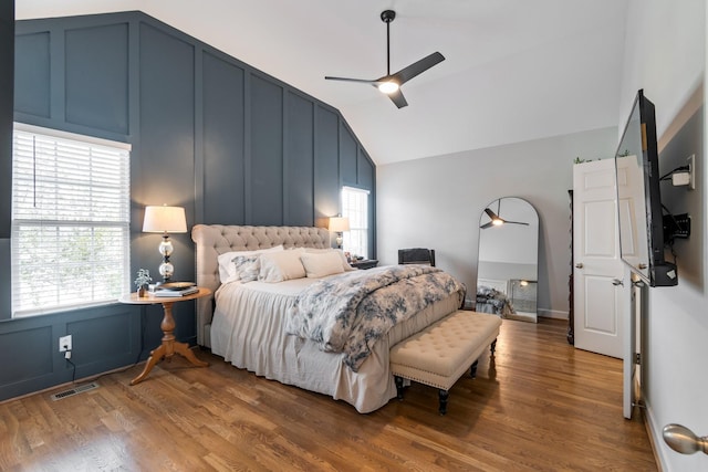 bedroom with ceiling fan, lofted ceiling, and wood-type flooring