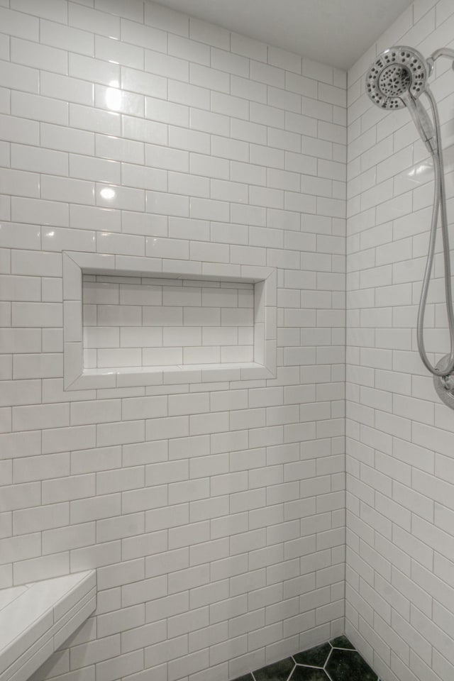 bathroom with tiled shower