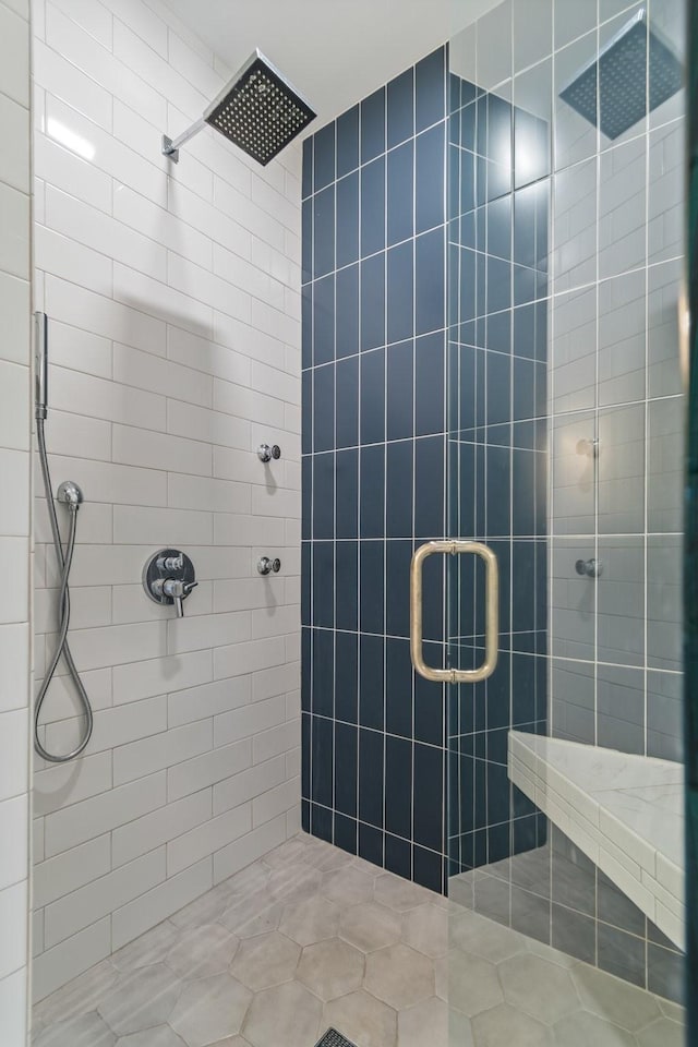 bathroom with a shower with door