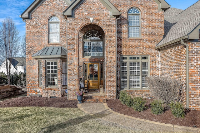 doorway to property featuring a lawn