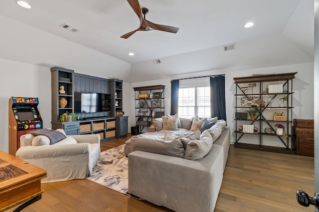 living room with ceiling fan, dark wood-type flooring, and lofted ceiling