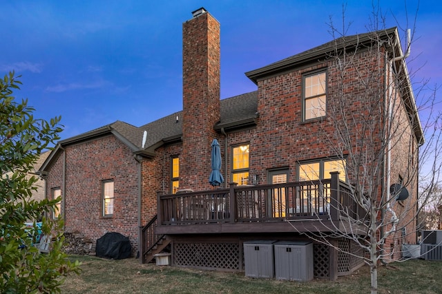 rear view of property featuring a wooden deck and central air condition unit