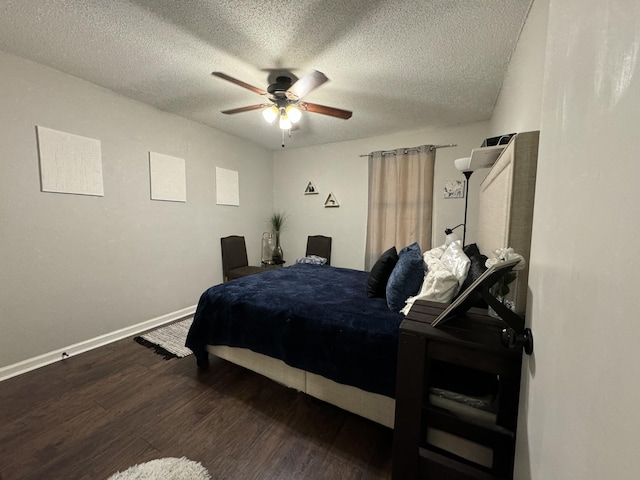 bedroom featuring a textured ceiling, ceiling fan, and dark hardwood / wood-style flooring