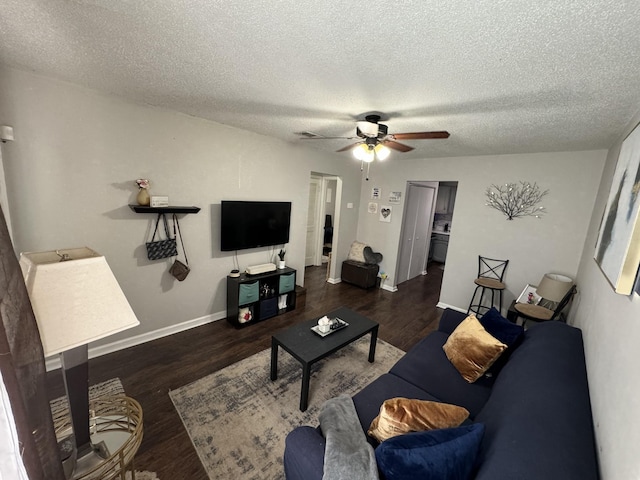 living room featuring dark wood-type flooring and a textured ceiling