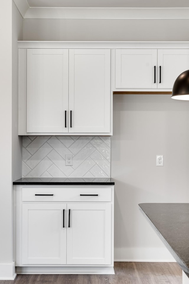 bar featuring white cabinets, hardwood / wood-style floors, and tasteful backsplash