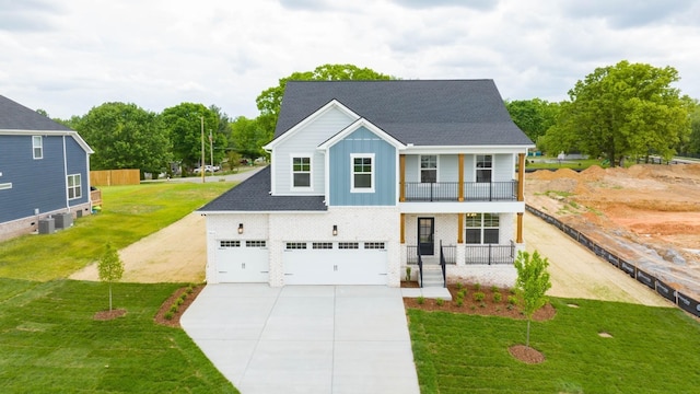 view of front facade featuring a garage, a balcony, covered porch, central air condition unit, and a front lawn