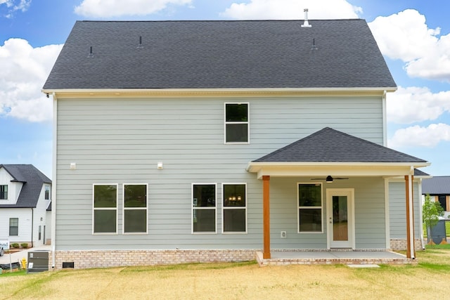 rear view of house with a patio area, a lawn, and ceiling fan