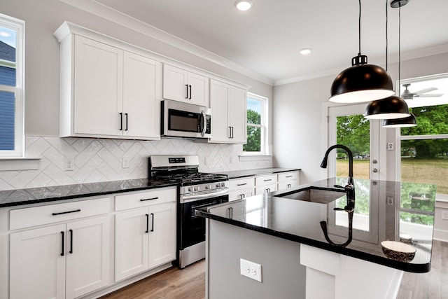 kitchen featuring sink, white cabinetry, and appliances with stainless steel finishes