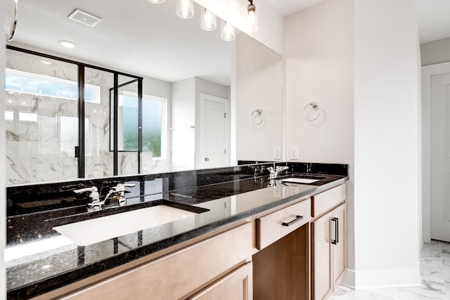 bathroom with a shower with door and vanity