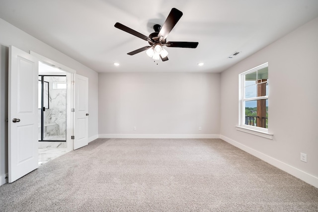 empty room featuring light carpet and ceiling fan