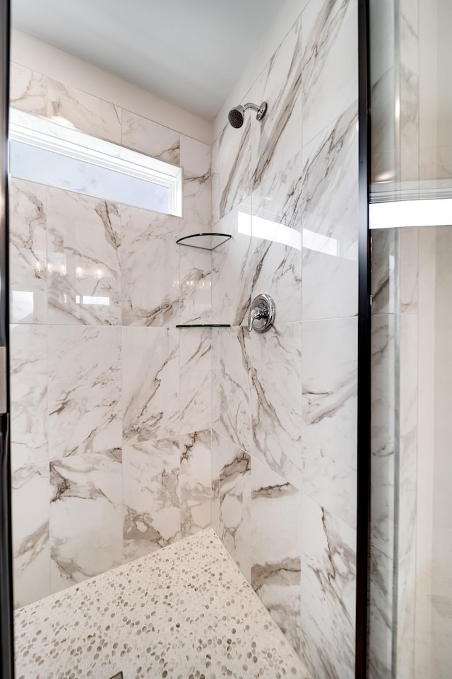 bathroom with a tile shower