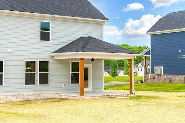 rear view of property featuring a yard and a patio