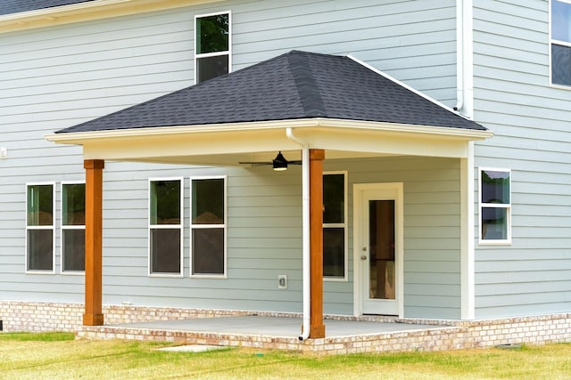 rear view of property with a patio and ceiling fan