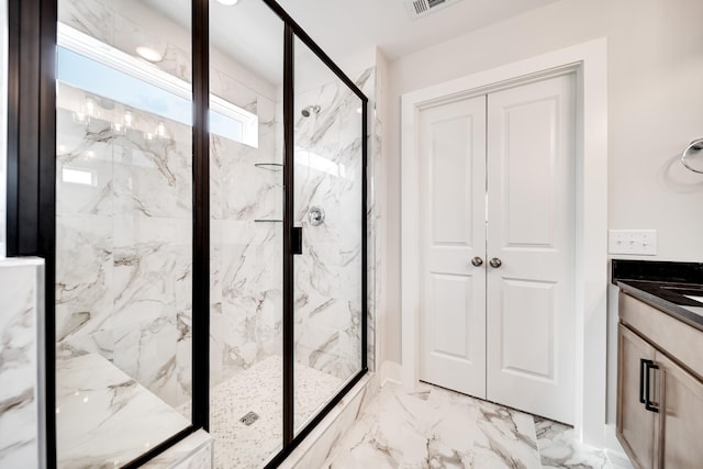 bathroom featuring vanity and a shower with shower door