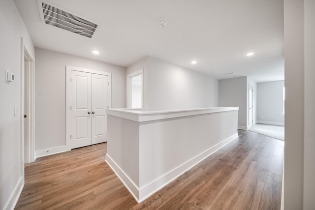 corridor featuring light hardwood / wood-style floors