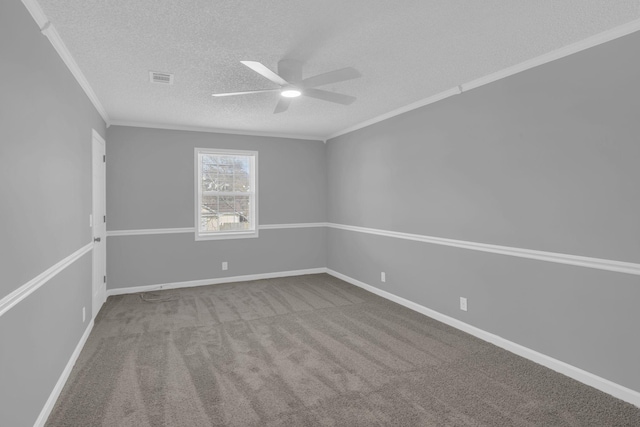 carpeted empty room featuring ceiling fan, a textured ceiling, and ornamental molding