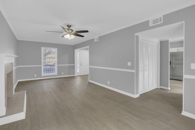 unfurnished living room with hardwood / wood-style flooring, ceiling fan, and ornamental molding