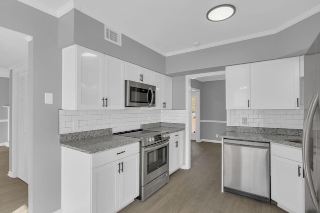 kitchen featuring light stone counters, light wood-type flooring, white cabinetry, and stainless steel appliances