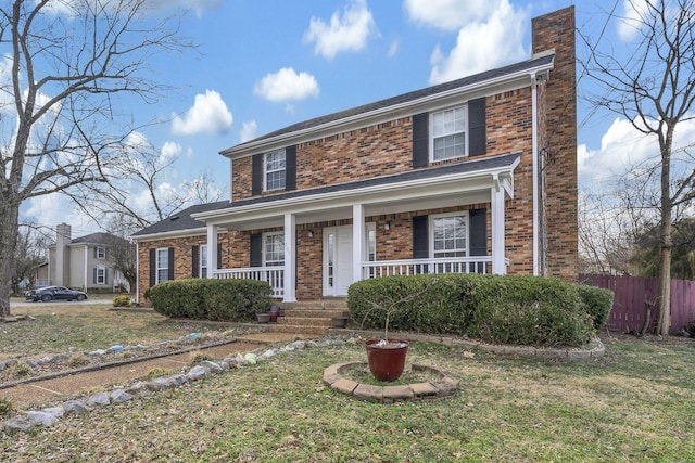 view of front of property with a front yard and a porch