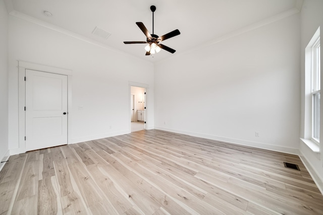 interior space featuring light wood-type flooring, ceiling fan, and ornamental molding