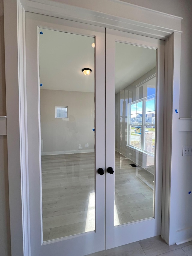 interior space with french doors and tile patterned flooring