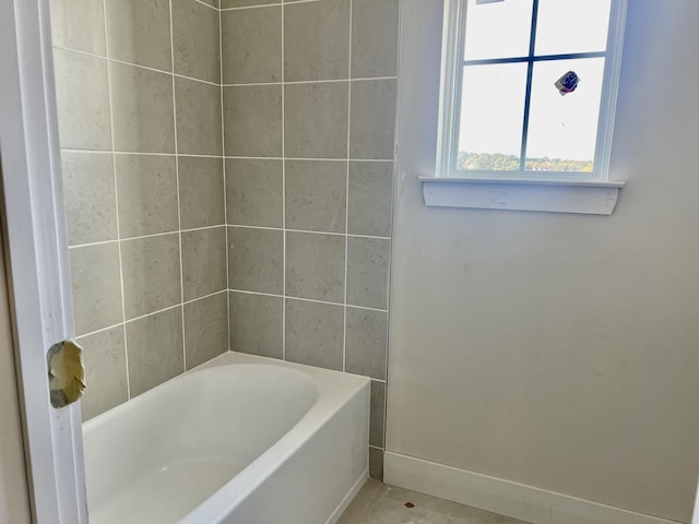 bathroom featuring a washtub and tile patterned floors