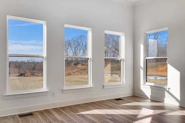 unfurnished room featuring hardwood / wood-style flooring