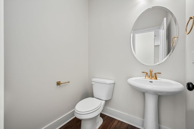 bathroom with sink, hardwood / wood-style floors, and toilet