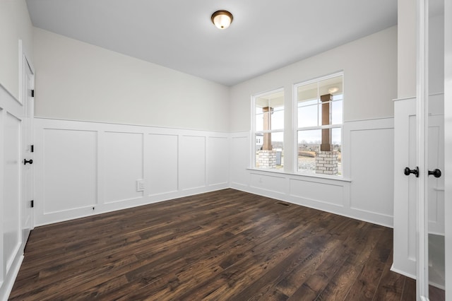 empty room with dark hardwood / wood-style flooring