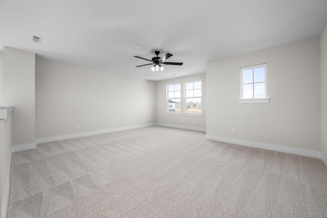 carpeted empty room featuring ceiling fan