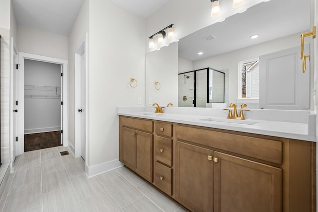 bathroom with a shower with door and vanity