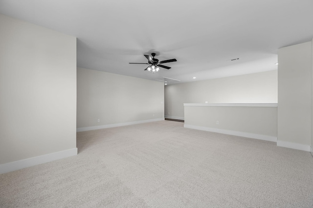 carpeted spare room featuring ceiling fan