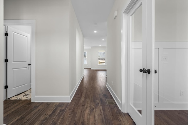 hallway with dark hardwood / wood-style floors