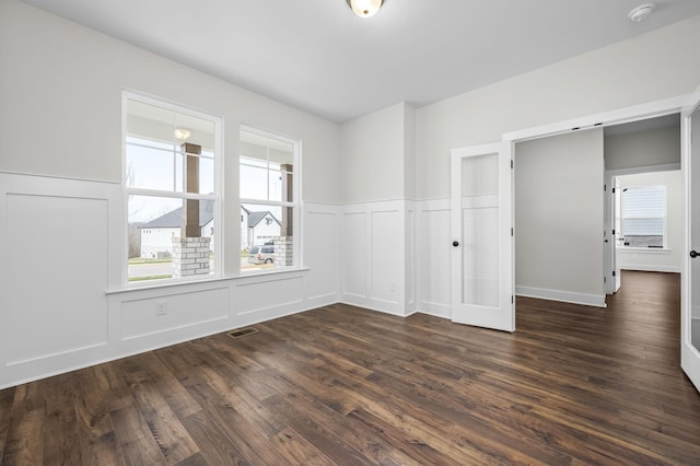 spare room featuring dark hardwood / wood-style flooring