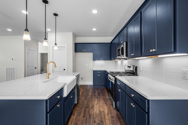 kitchen with decorative light fixtures, a center island with sink, dark hardwood / wood-style flooring, and appliances with stainless steel finishes