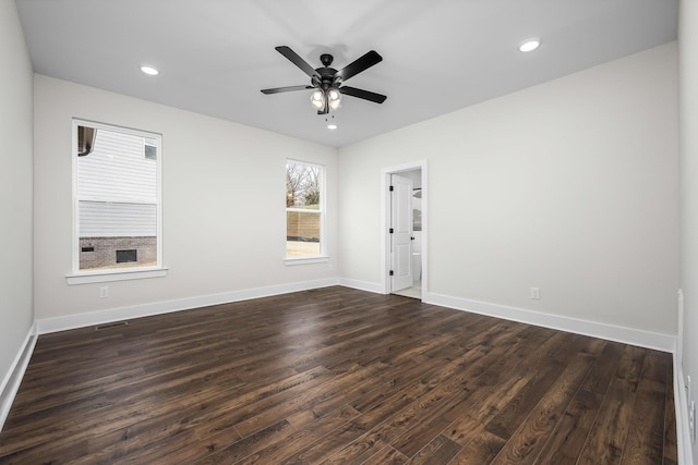 spare room featuring ceiling fan and dark hardwood / wood-style floors