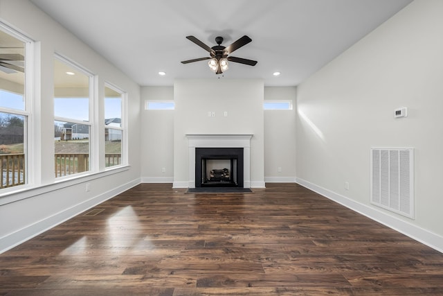 unfurnished living room featuring dark hardwood / wood-style floors and ceiling fan