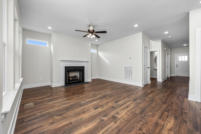 unfurnished living room with ceiling fan and dark wood-type flooring