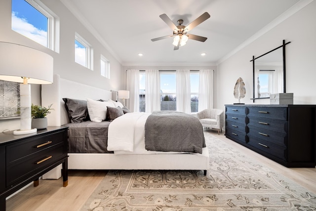 bedroom featuring multiple windows, ceiling fan, and light hardwood / wood-style flooring