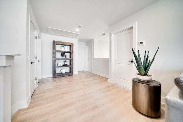 corridor with light hardwood / wood-style flooring