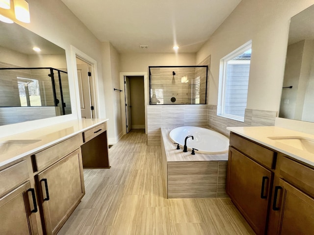 bathroom with vanity and plus walk in shower