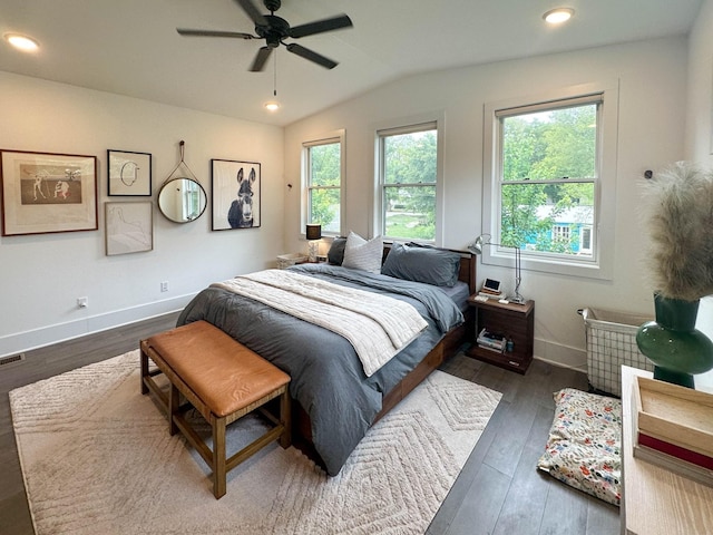 bedroom with ceiling fan, vaulted ceiling, and dark wood-type flooring